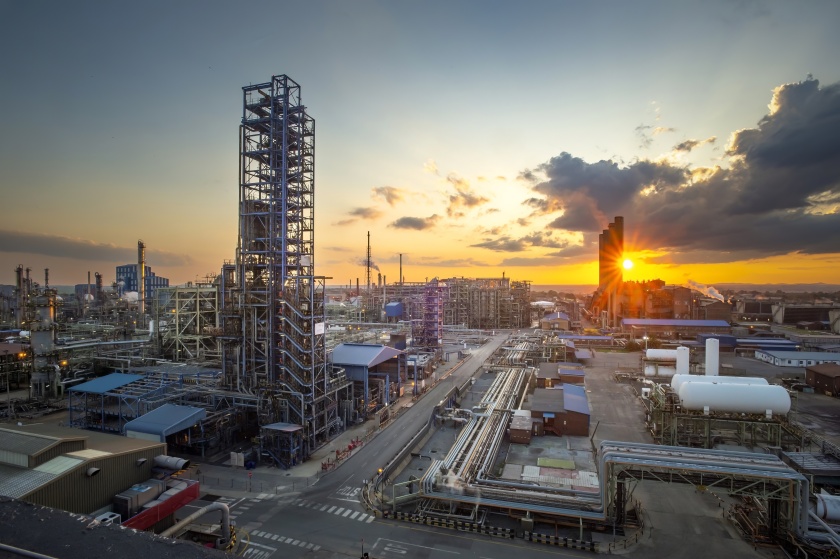 The photo shows Sasol's Sasolburg site in South Africa. In the foreground is the massive, 60-meter-tall FTDR (Fischer-Tropsch Design Reactor). This reactor was used for semi-commercial testing of one of the scaled-up CARE-O-SENE catalysts. It has a capacity of 300 barrels/day.