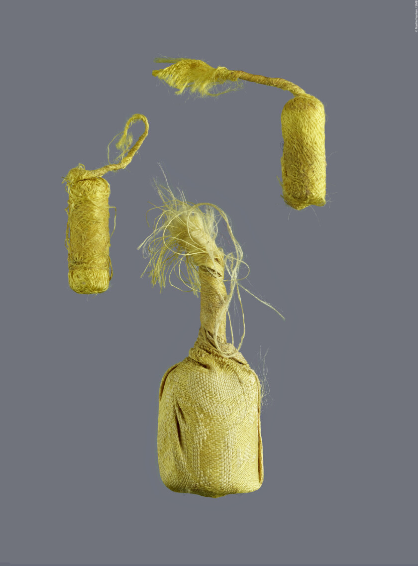 Three tiny scrolls between 3 and 5 centimetres long were found inside the shrine. They are wrapped in silk and glued together.