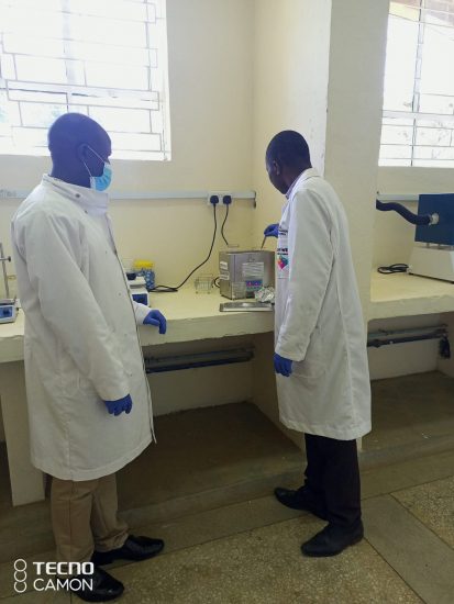 Robert (right) cleans in an ultrasonicator the substrates to be used in solar cell fabrication.