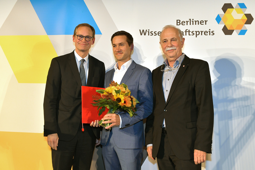 Die Preisverleihung im Dinosauriersaal des Museums f&uuml;r Naturkunde Berlin: Der Regierende B&uuml;rgermeister Michael M&uuml;ller, Preistr&auml;ger Steve Albrecht und Laudator J&uuml;rgen Mlnyek.